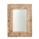 White background image of a carved mango wood mirror Anumati with floral motifs and distressed finish. A handcrafted Indian furniture piece perfect for vintage home decor and artisanal interiors.