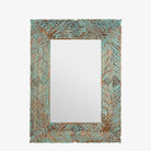 White background image of a carved mango wood mirror Anumati with floral hand-carving and distressed finish. A unique Indian furniture piece perfect for vintage home decor and bohemian interiors.