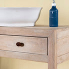 Close up image of a Ibiza style reclaimed wood console table with two drawers and a lower shelf, whitewashed finish, 100 × 40 × 90 cm.