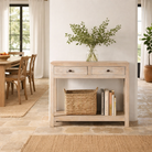 Lifestyle image of a Ibiza style reclaimed wood console table with two drawers and a lower shelf, whitewashed finish, 100 × 40 × 90 cm.