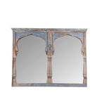 White background image of a antique arch mirror Anuradha made from a reclaimed teak triple window frame with indigo patina and carved columns. A large, unique Indian furniture piece for vintage and bohemian interiors.