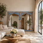 Lifestyle image of a antique arch mirror Anuradha made from a reclaimed teak triple window frame with indigo patina and carved columns. A large, unique Indian furniture piece for vintage and bohemian interiors.
