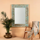 Carved mango wood mirror Anuvinda with turquoise finish and hand-carved detailing. A vibrant vintage home decor piece reflecting traditional Indian craftsmanship.