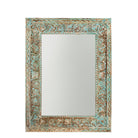 White background image of a carved mango wood mirror Anuvinda with turquoise finish and hand-carved detailing. A vibrant vintage home decor piece reflecting traditional Indian craftsmanship.