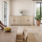 Lifestyle image of a sandblasted wood sideboard with 2 drawers and 4 cabinets, living room furniture in relaxed Ibiza style.