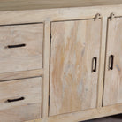 Close up image of a sandblasted wood sideboard with drawers and cabinets, living room furniture in relaxed Ibiza style.