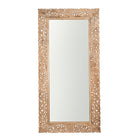 White background image of a carved mango wood mirror Apsara in white-washed finish with hand-carved floral design. A tall, artisan-crafted piece of Indian furniture ideal for vintage home decor and bohemian interiors.
