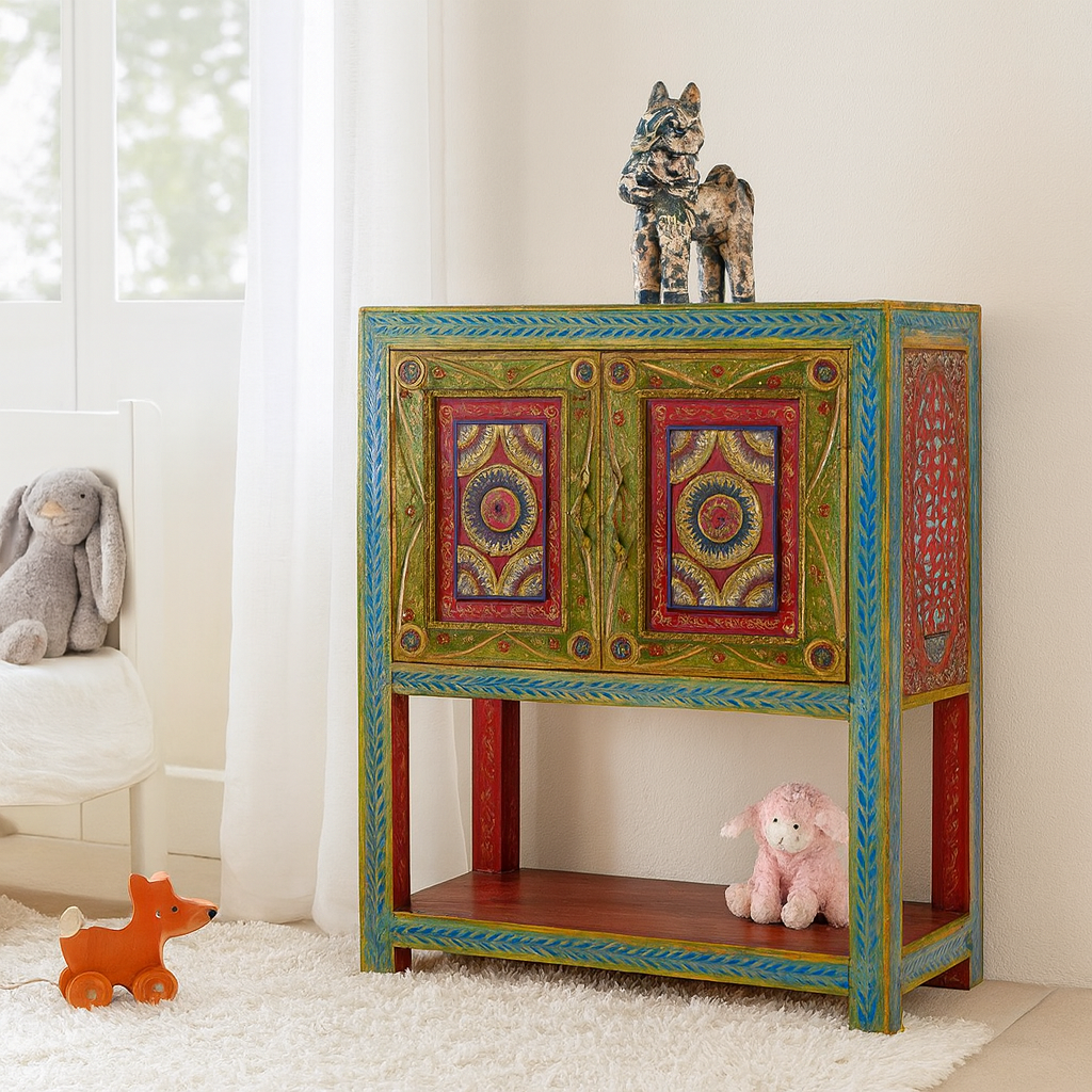 Lifestyle imagination of a small hand-painted console made from reclaimed wood, featuring vibrant decorative motifs in red, green, blue, and gold on double doors, with intricate floral and geometric patterns and a lower open shelf for added display.
