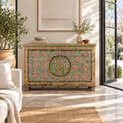 Lifestyle image of a Armaan hand painted reclaimed teak wood storage chest with colourful floral motifs and traditional iron fittings, 151cm wide