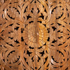 Close up image of a Hand-carved mango wood wall panel with intricate floral design and natural finish – Aruna model by Om Home & Garden