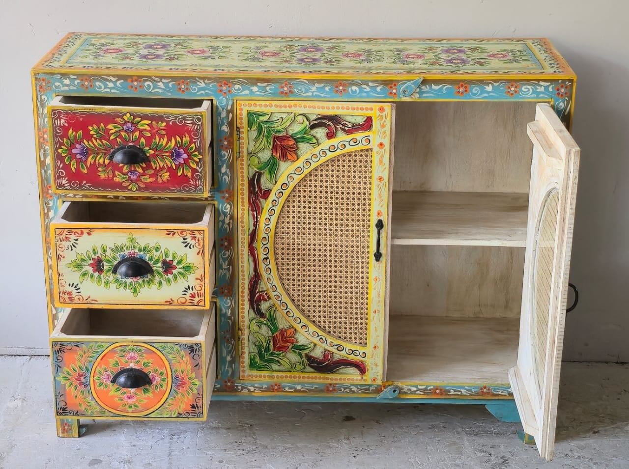 Image showing open doors of a hand painted sideboard Ashara made of mango wood with rattan inserts; Ibiza-inspired boho chic furniture, 120 × 40 × 92 cm.