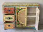Image showing open doors of a hand painted sideboard Ashara made of mango wood with rattan inserts; Ibiza-inspired boho chic furniture, 120 × 40 × 92 cm.