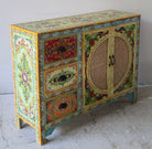 Side angle image of a hand painted sideboard Ashara made of mango wood with rattan inserts; Ibiza-inspired boho chic furniture, 120 × 40 × 92 cm.