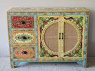 Image of a hand painted sideboard Ashara made of mango wood with rattan inserts; Ibiza-inspired boho chic furniture, 120 × 40 × 92 cm.