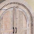 Close up picture of Ashwin wardrobe with arched carved doors, a unique furniture design from our mango wood furniture collection.
