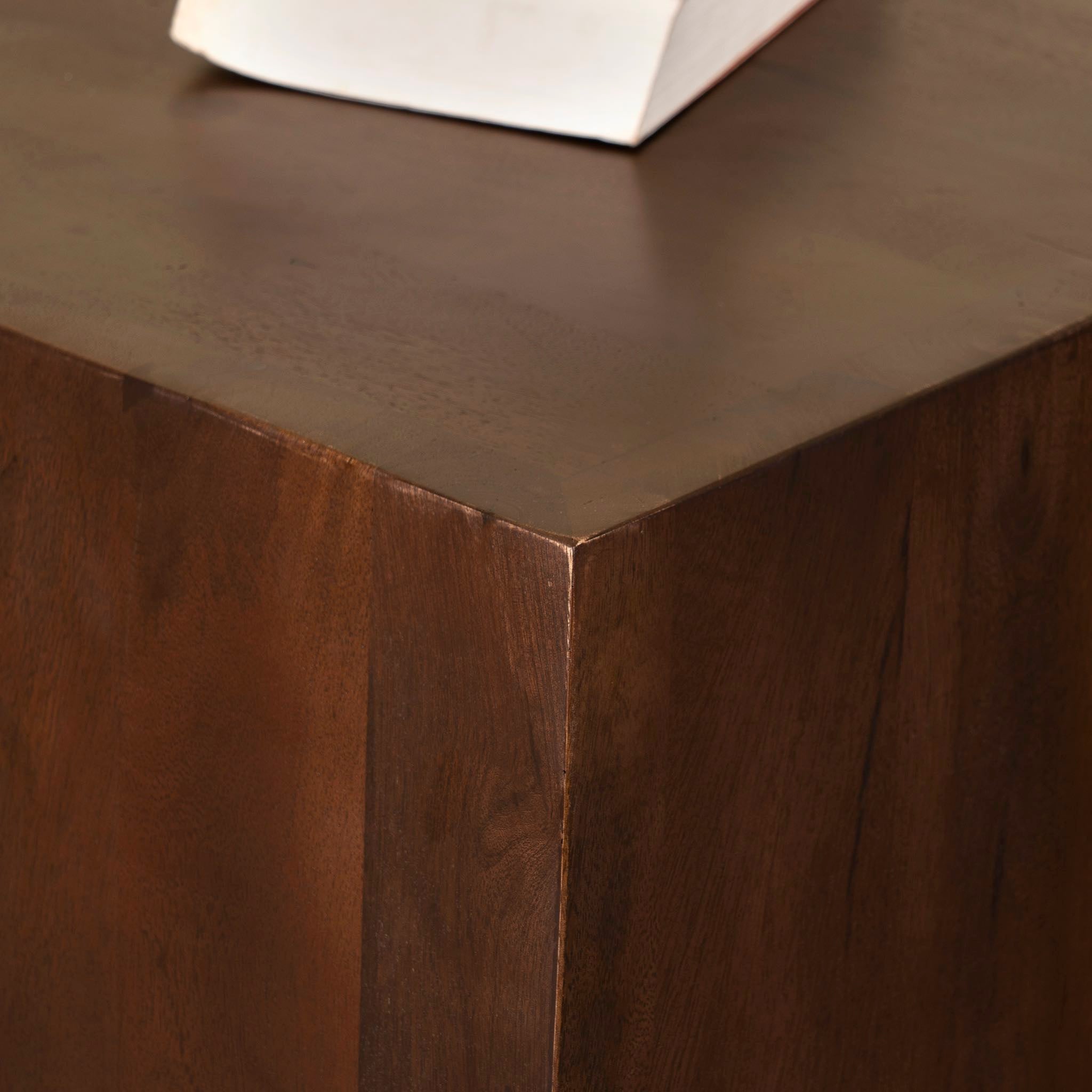 Close up image of a tall minimalist side table in solid mango wood, coffee table mango wood, Indian home decor, 30 × 30 × 50 cm.