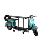 White background image of a house bar crafted from a full vintage Indian Bajaj scooter with industrial metal frame and wooden shelves, featuring original patina and retro design elements.

