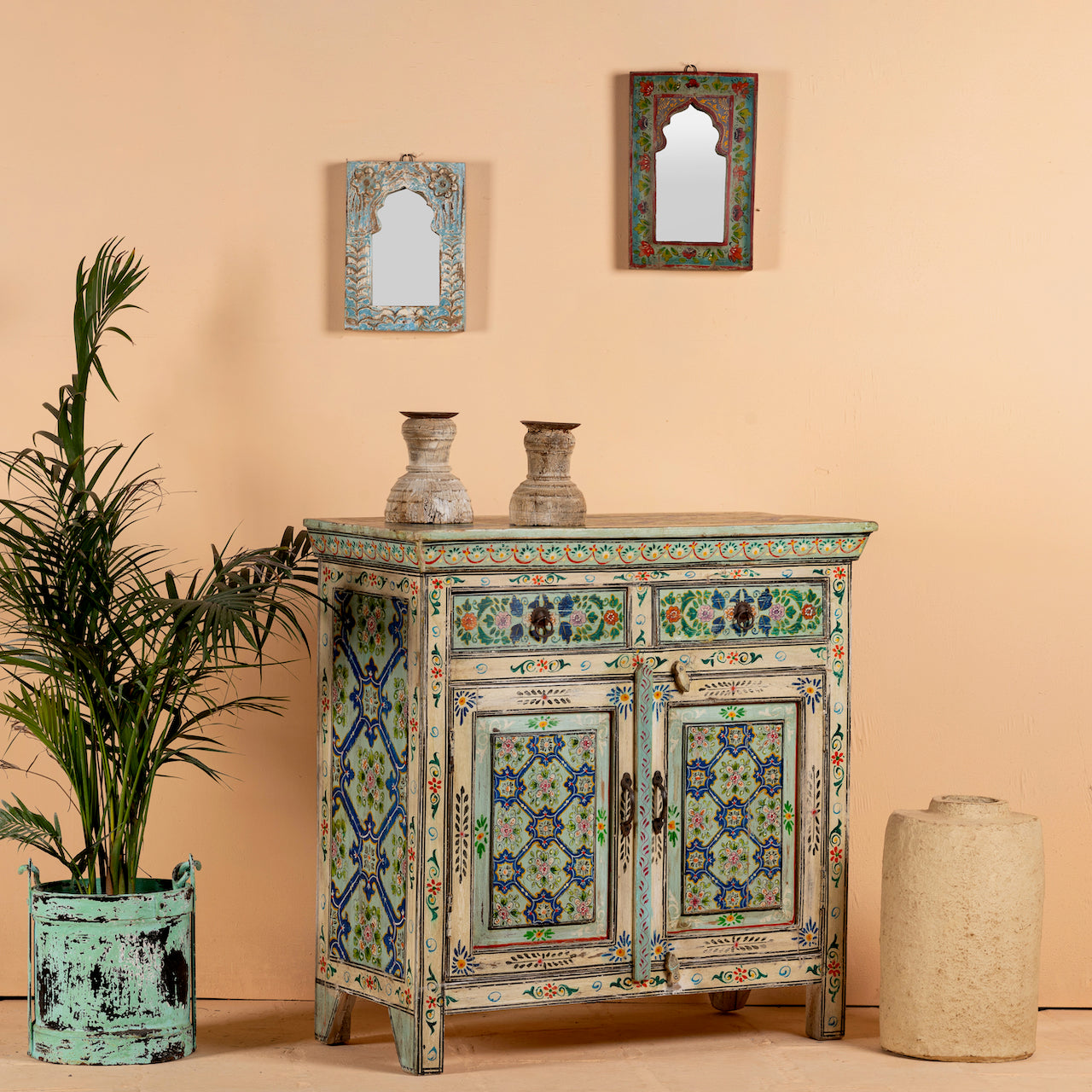 Side angle image of a hand painted cabinet made from reclaimed wood with colourful traditional Indian motifs, 90 × 90 × 40 cm.