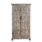 White background image of a hand-carved mango wood cabinet Ava in a vintage distressed finish with floral motifs. A stylish piece of mango wood furniture and vintage home accessory with practical storage and timeless charm.