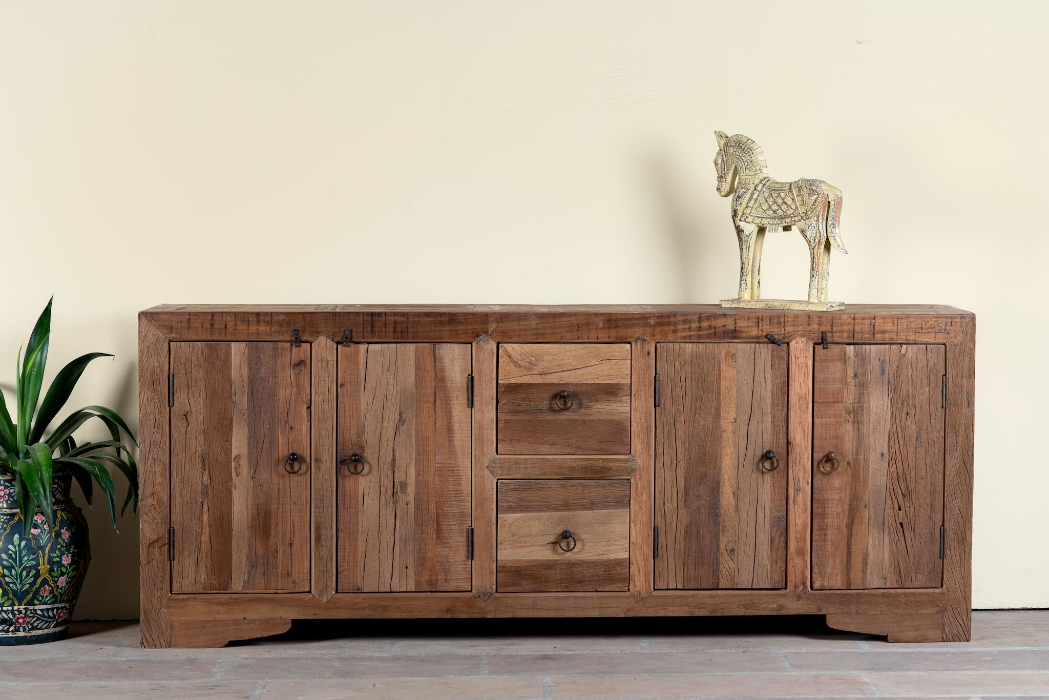 Reclaimed wood sideboard Avana in a rustic minimalistic style with multiple cabinets and drawers, showcasing natural wood grain and simple iron handles.