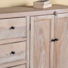 Close up image of a sandblasted wood sideboard with drawers and cabinets, living room furniture in relaxed Ibiza style.
