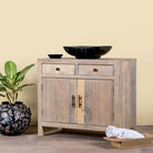 Side angle image of a reclaimed wood cupboard with 2 drawers and 2 doors, rustic finish; sustainable bathroom furniture, 90 × 50 × 80 cm.