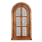 White background image of a handcrafted carved wooden wardrobe in half-round design with whitewashed lattice panels – bedroom furniture with Mediterranean flair and artistic detail.