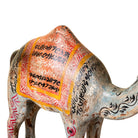 Close up image of a hand-painted wooden dromedary sculptures in different colours – decorative camel figures made from reclaimed wood, inspired by Indian folk art.