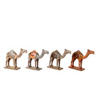 White background image of a hand-painted wooden dromedary sculptures in different colours – decorative camel figures made from reclaimed wood, inspired by Indian folk art.