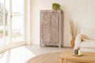Lifestyle image of a handcrafted cabinet with reclaimed Indian window frame doors, white-washed finish, and iron accents – vintage home decor with teak furniture appeal.