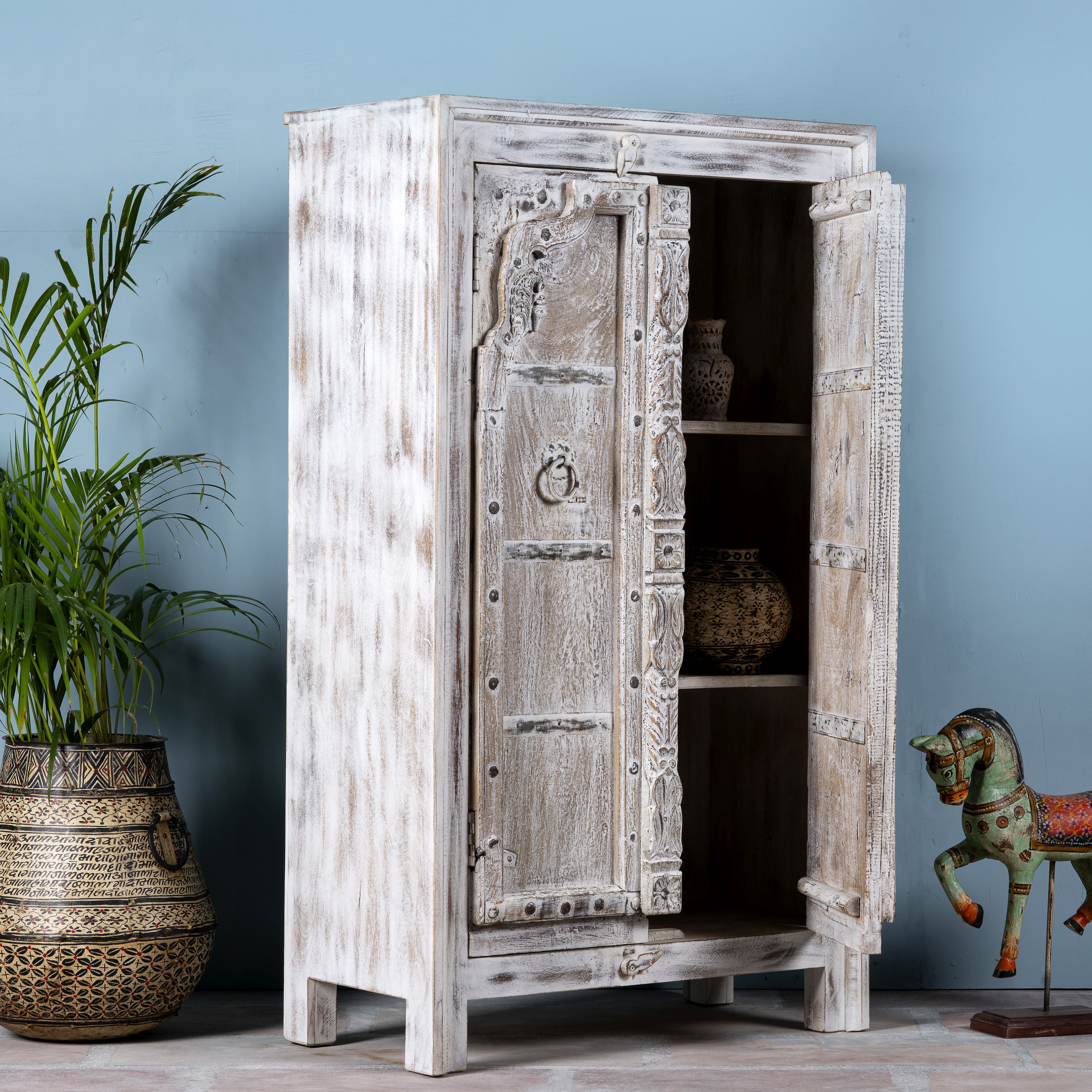 Side angle with open door image of a handcrafted cabinet with reclaimed Indian window frame doors, white-washed finish, and iron accents – vintage home decor with teak furniture appeal.