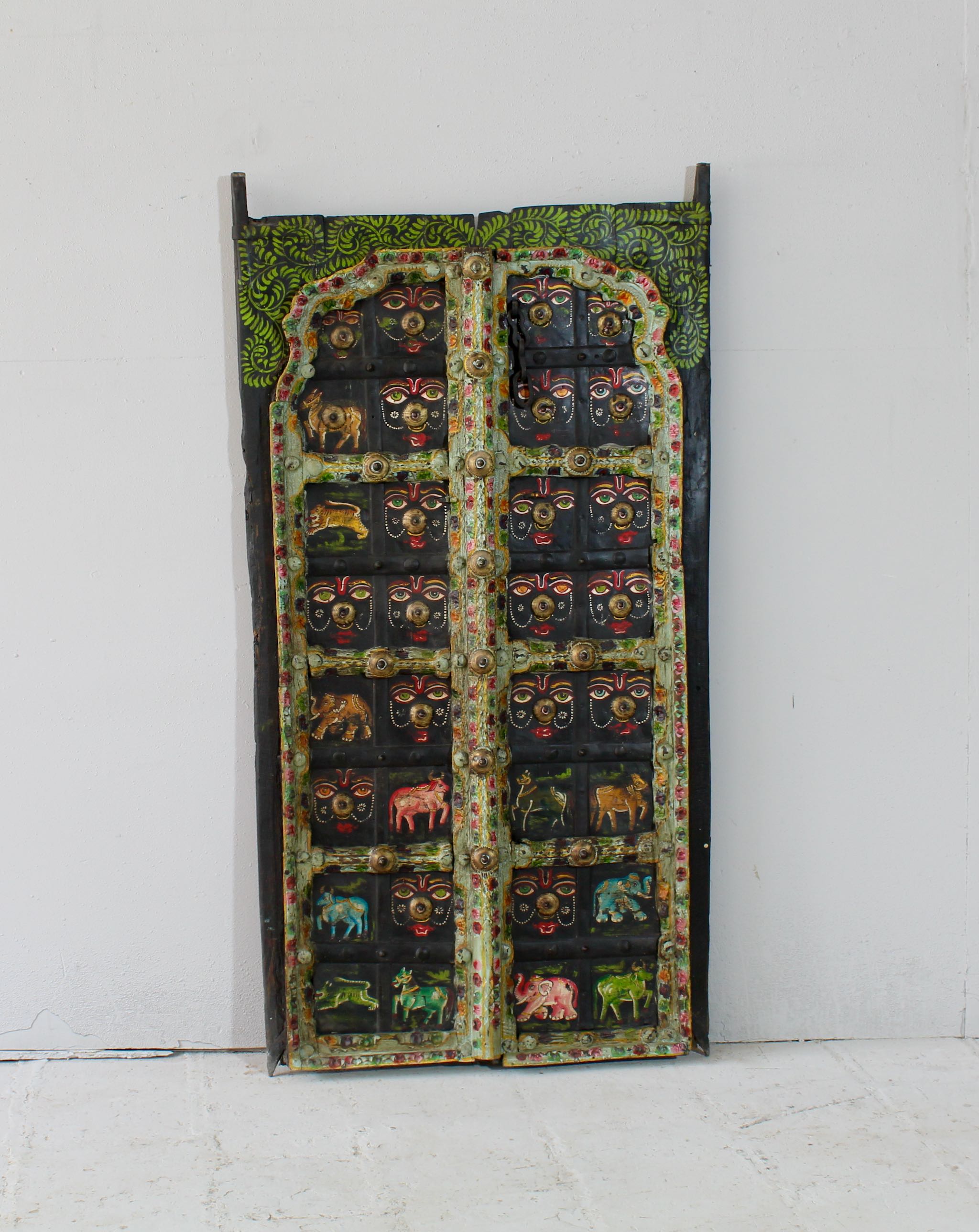 Ayandh hand-painted teak door panel featuring sacred animal motifs and folk figures with a weathered floral frame—a vibrant example of teak door panels and unique Indian wall decoration.