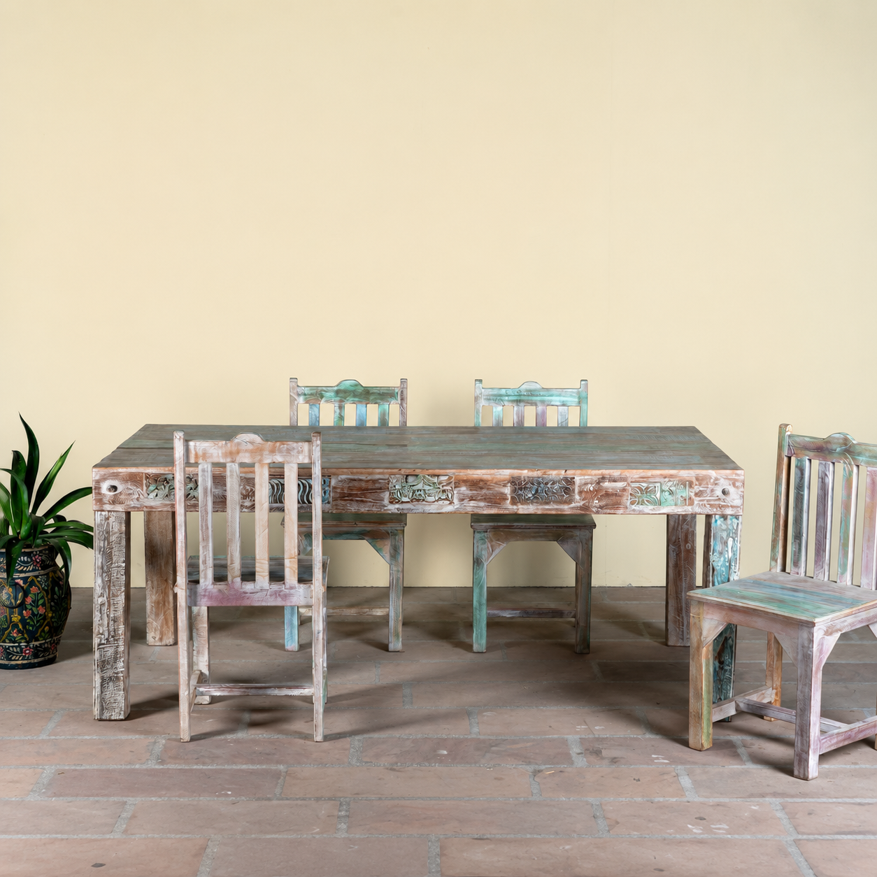 Image of a reclaimed wood dining set Ayla with one vintage table and six rustic chairs. A handcrafted bohemian interior piece combining sustainable materials with artistic, timeworn charm.