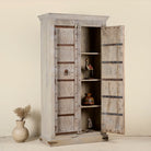 Open door image of a old door cabinet with reclaimed teak doors, floral carvings, and iron accents; artisan teak wood wardrobe with mango wood frame, 100 × 44 × 206 cm.