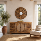 Lifestyle imagination of a of a round mango wood mirror Babra with concentric carved design and mirror inlays. A piece of unique wall decor combining artisanal craftsmanship and rustic bohemian charm.