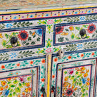 Close up image of a of a hand painted reclaimed wood storage cabinet in vintage floral design.