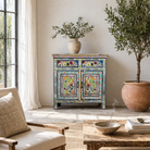 Lifestyle image of a hand painted reclaimed wood storage cabinet in vintage floral design.
