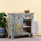 Side angle image with open door of a hand painted reclaimed wood storage cabinet in vintage floral design.