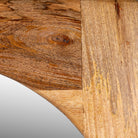 Close up image of a mango wood mirror Bana with tall, arched frame and natural finish. A handcrafted piece of rustic wall art perfect for Mediterranean and minimalist interiors.