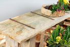 Close up image of a Beas handcrafted bench made from a reclaimed antique Indian half teak door with original iron fittings, solid teak wood construction, rustic Ibiza style, and versatile bench or table design, 170cm.