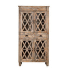 White background image of a vintage display cabinet made from solid mango wood with glass doors and shelving – handcrafted Ibiza-style showcase with carved details.