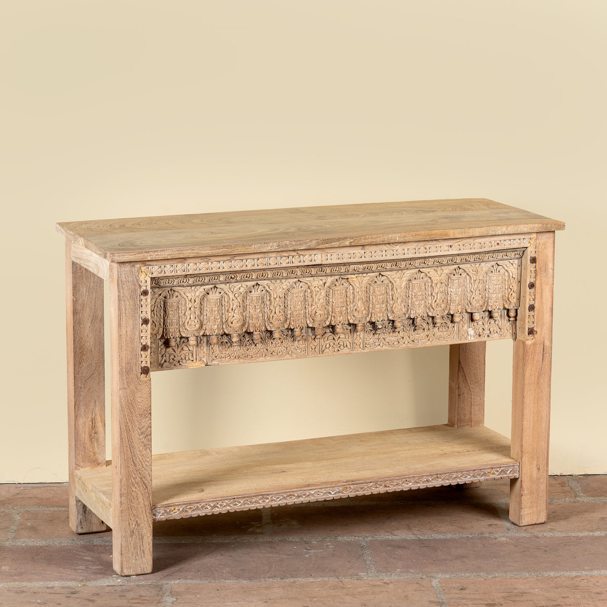 Side angle image of a Bhaskar reclaimed teak wood console table with carved old Indian house elements and lower storage shelf 118cm