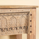 Close up image of a Bhaskar reclaimed teak wood console table with carved old Indian house elements and lower storage shelf 118cm
