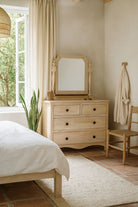 Lifestyle image of a Ibiza style Mango wood dressing table with five drawers and mirror, sandblasted whitewashed finish, 100 × 40 × 130 cm.