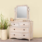 Side angle image of a Ibiza style Mango wood dressing table with five drawers and mirror, sandblasted whitewashed finish, 100 × 40 × 130 cm.