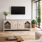 Lifestyle image of a hand-carved mango wood Mediterranean lowboard with floral engravings and whitewashed finish – carved wooden furniture combining traditional Indian craftsmanship with rustic elegance.