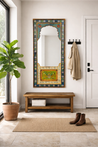 Lifestyle imagination of a painted mirror Bhuj with hand-carved floral design in vibrant colors, made from antique teak wood. A bold piece of unique Indian furniture with artistic and historic charm.