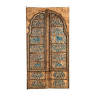 White background image of a hand-painted wooden wall panel made from an old window frame, featuring intricate blue floral patterns along with stylised animal motifs such as elephants and camels, set against a distressed golden-brown background with an arched top frame.

