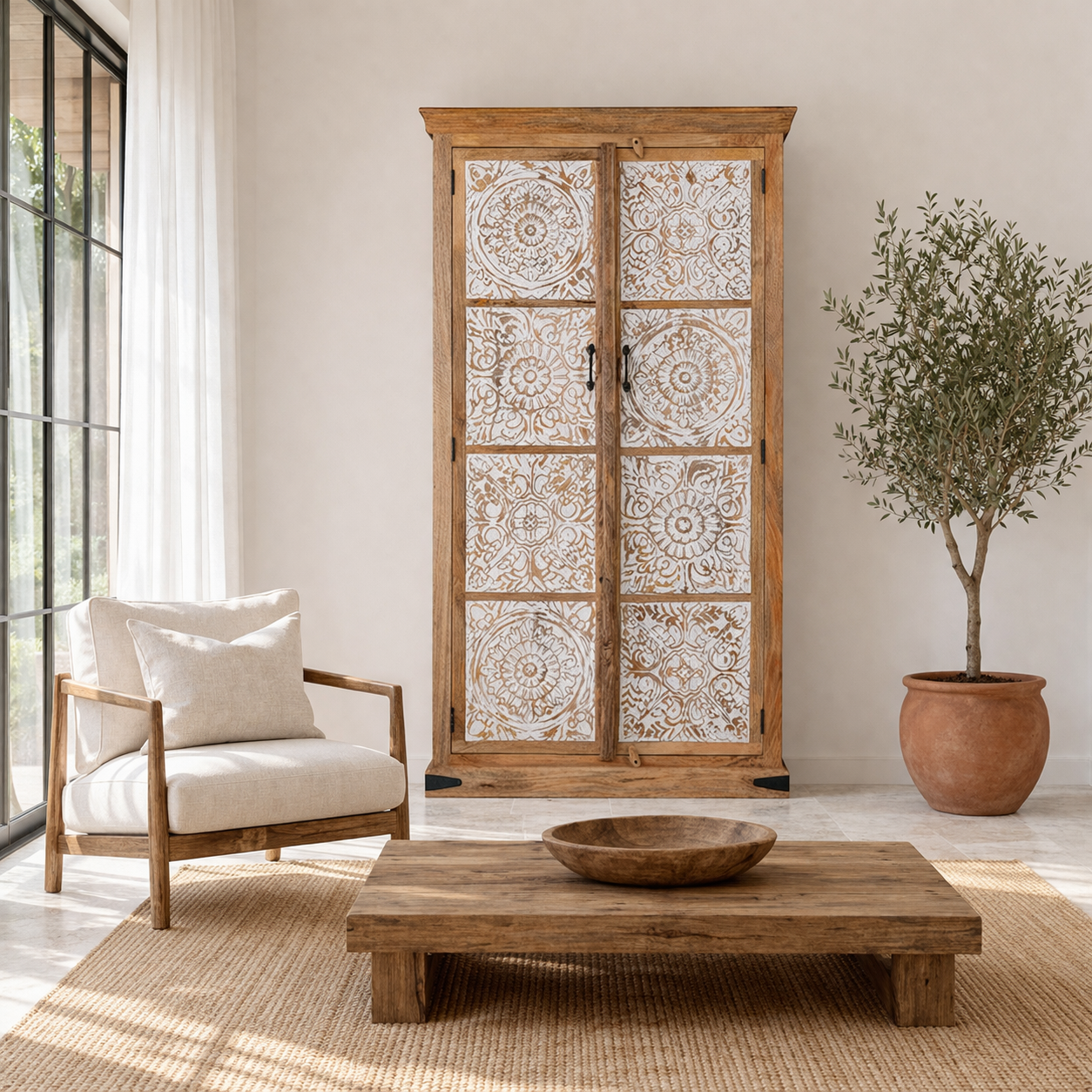 Lifestyle image of a mango wood wardrobe with whitewashed floral carvings, vintage furniture cabinet in carved wood, 190 × 105 × 42 cm.