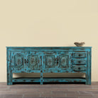 Kalpana reclaimed wood console table with blue distressed finish, carved doors, three drawers, enclosed storage and open lower shelf.